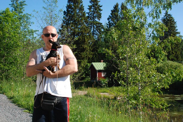 Esa Takala lenkkeilee Pesänlammen rannassa Elea-koiran kanssa. Lammen ulkonäkö harmittaa.