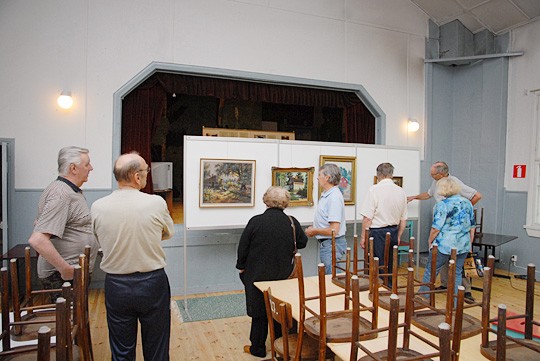 Matilda-talossa koottiin näyttelyä maanantaina. Yksi taustan tauluista on vastarannalla, Kemiön Kiilassa maalattu. Talkoissa olivat vas. Esko Alve, Rauno Leino, Marita Mustonen, Jouko Roos, Pekka ja Irma Gustafsson ja Risto Jaakkola.