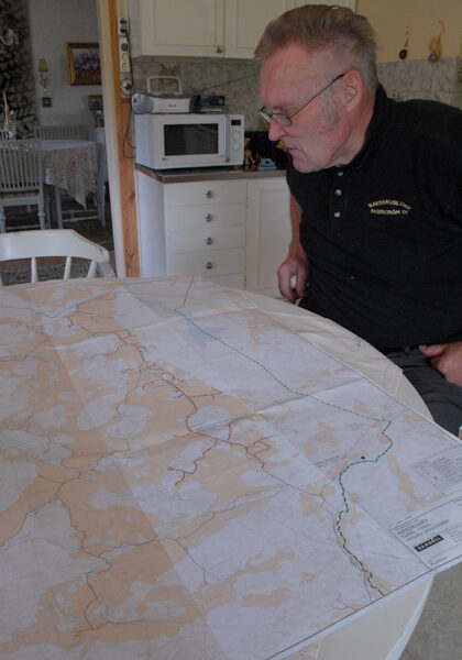 Mahdollinen viemärilinja luikertelee punaisena pitkin karttaa. Viljo Kurppa syynää Perniön kunnan teettämää suunnitelmaa.