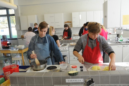 Työnjako on selvä; Unto Salminen ruskistaa jauhelihaa ja Oskari Uusitalo kuutioi kesäkurpitsaa.