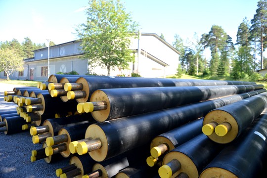 Kaukolämpöputket odottavat jo asennustaan liikuntahallin pihalla.