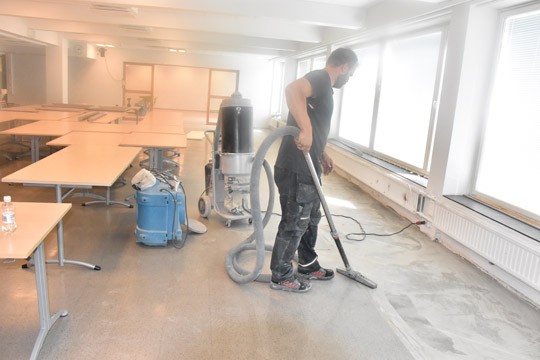 Kusti Räsänen imuroi tiistaina ruokasalia remontoinnin jäljiltä.